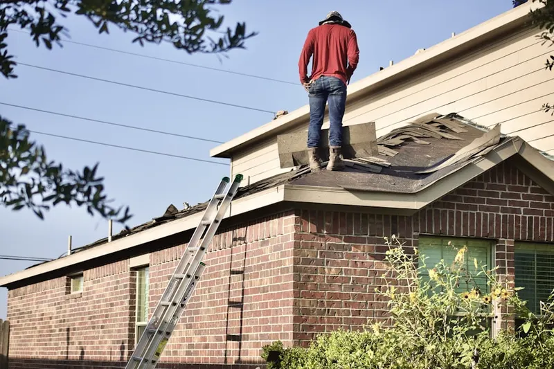 Professional roofer working on a residential roof in Erwin